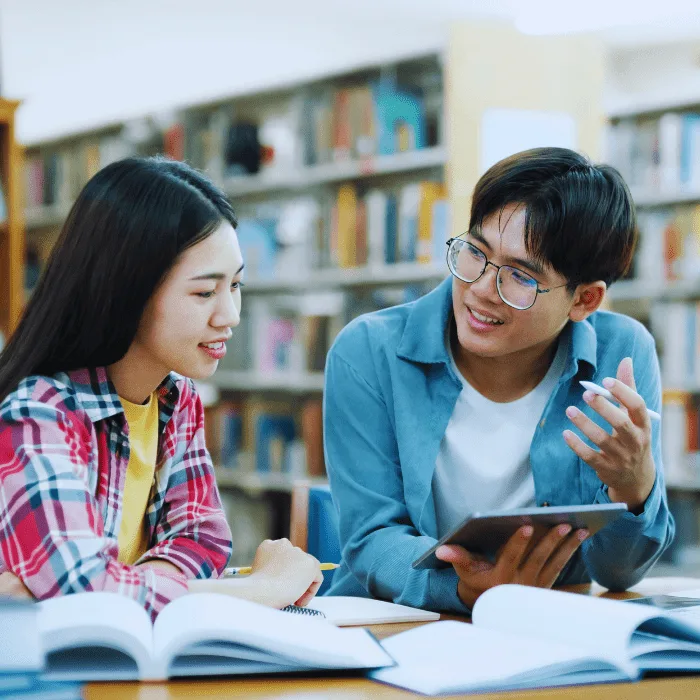 Cloud software collaboration Indonesia students studying with digital tablet and open books modern educational technology teamwork in library BestCloud Indonesia
