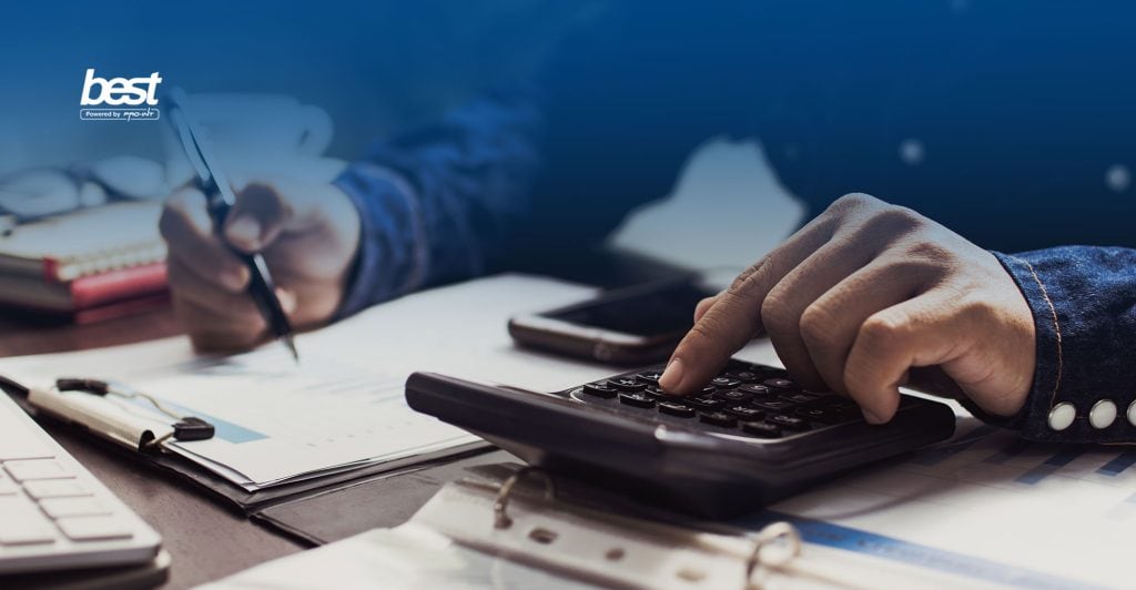 Person calculating taxes with a calculator and documents illustrating PPh 21 and PPh 23 tax concepts in Indonesia