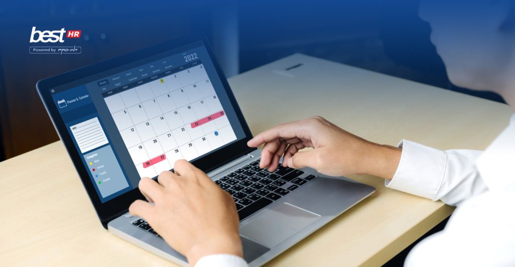 Digital attendance system displayed on a laptop showing a calendar and attendance data used for managing employee presence and overtime efficiently